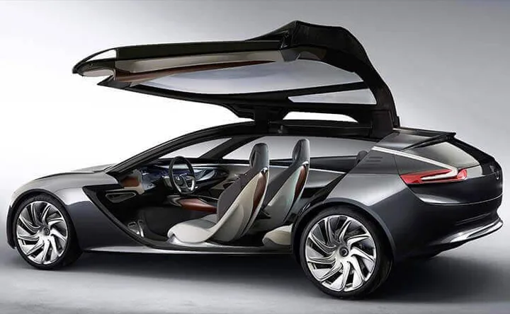 Grey concept fastback with its upward-opening door raised, showing the cabin