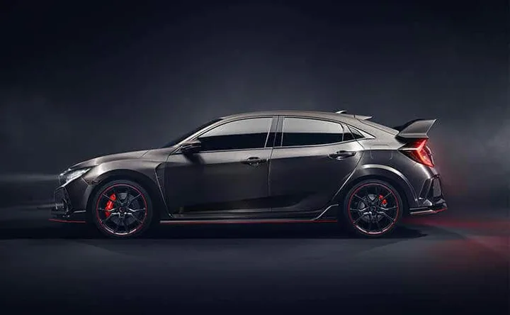 Dark grey performance hatchback shown in side profile with a rear wing