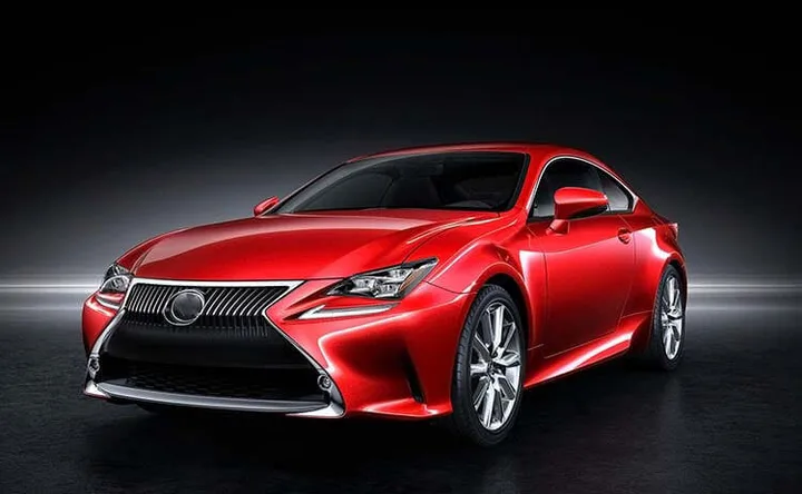Red coupe shown from the front three-quarter view against a dark background