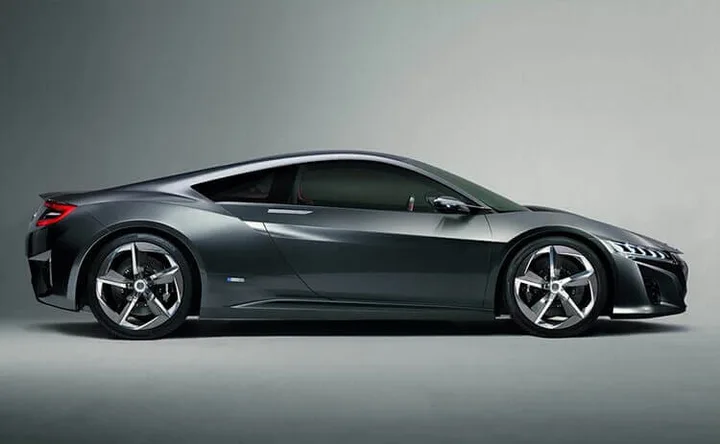 Dark grey two-door coupe shown in side profile in a studio setting